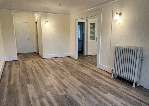 an empty living room with a radiator
